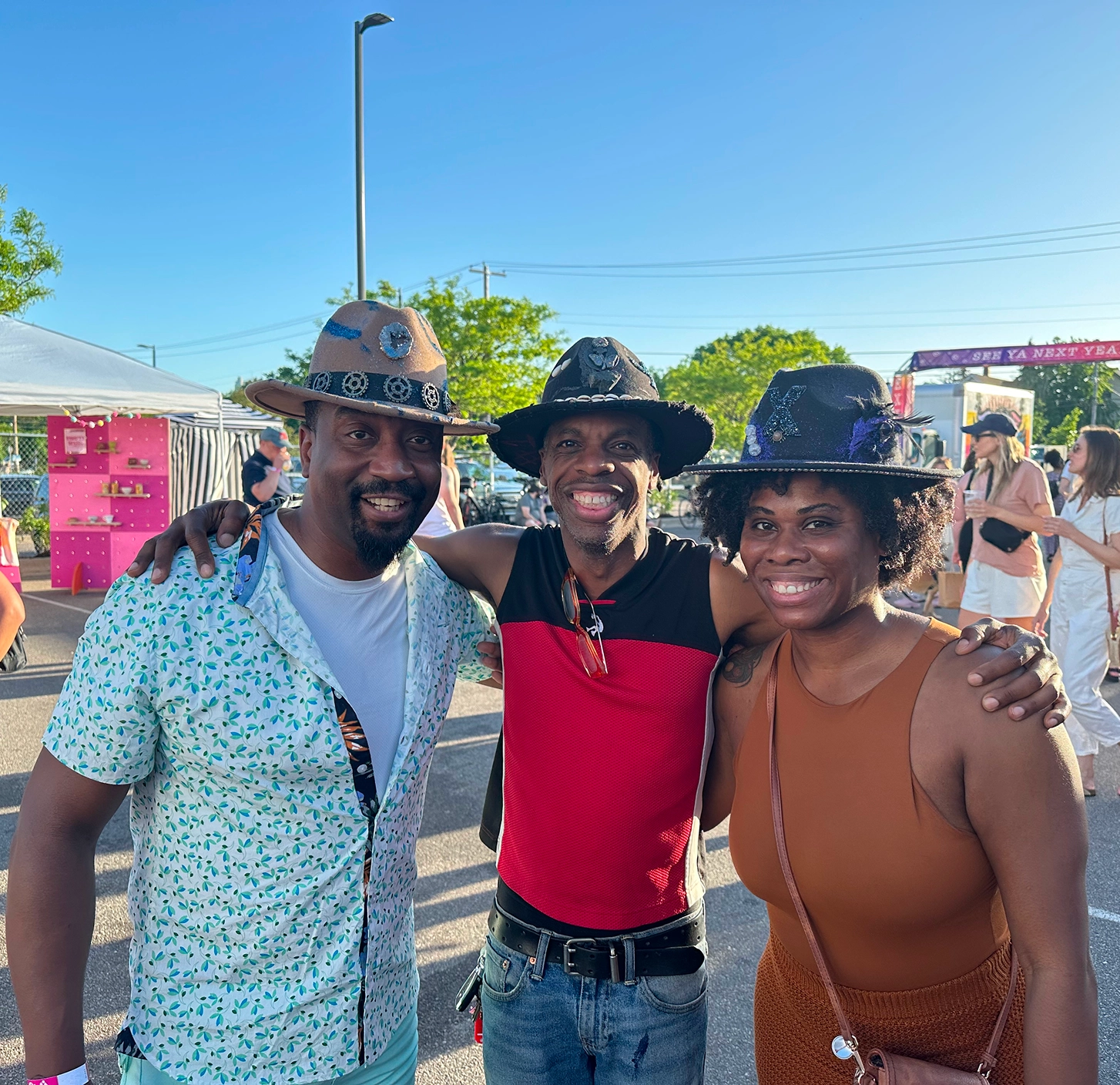 Friends posing at an outdoor festival